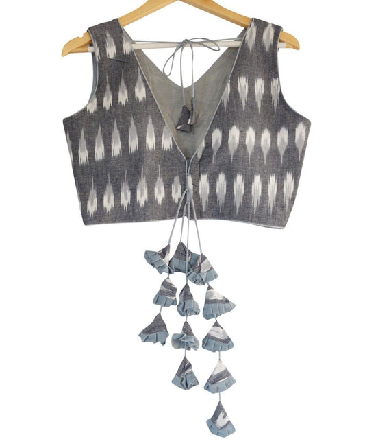 Set trends with our Trendsetting Grey Ikkat V-neck Readymade Blouse featuring designer tassels. Elevate your style effortlessly with this chic and fashionable piece. Shop now for an exquisite addition to your wardrobe.