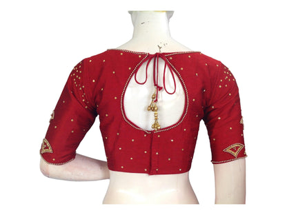 Step into regal splendor with our Maroon Aari Handwork Boat Neck Saree Blouse, designed to elevate your Indian Ethnic Wedding Choli. Shop now for an unforgettable bridal ensemble