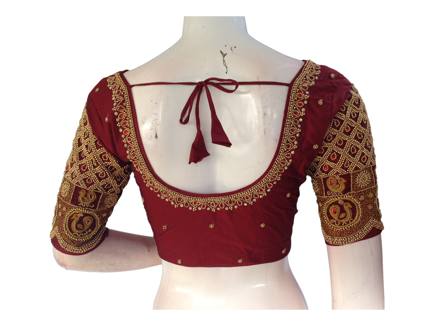 Complete your bridal ensemble with our Maroon Bridal Handwork Readymade Saree Blouse. Crafted with intricate details, this blouse adds elegance and tradition to your wedding attire. Shop now for the perfect Indian Ethnic Wedding Choli Top