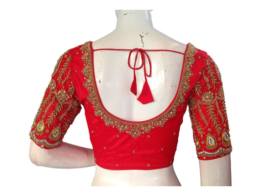 Complete your bridal look with our exquisite Red Bridal Handwork Readymade Saree Blouse. Crafted to perfection, this blouse adds a touch of elegance and tradition to your wedding attire. Shop now for the perfect Indian Wedding Choli Top online.