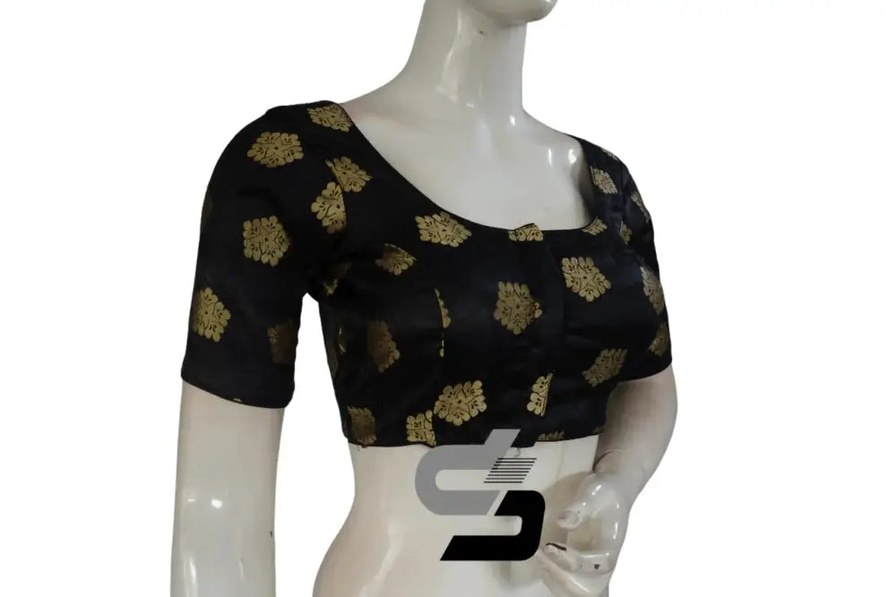 Close up of woven brocade patterns on a black designer saree blouse