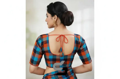 Woman wearing a colorful checkered blouse with an open back design.