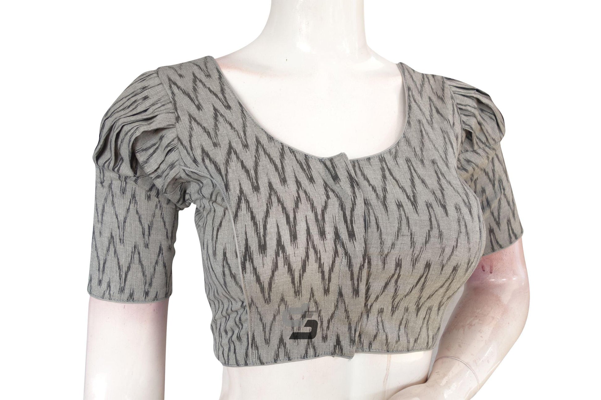 Elevate your style effortlessly with our chic Grey Ikkat Cotton Designer Blouse featuring puff sleeves. This versatile piece adds a touch of sophistication to any ensemble, making it perfect for both casual and formal occasions. Experience comfort and elegance in one stylish package!
