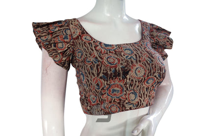 Command attention with "Maroon Majesty," our Kalamkari Cotton Blouse with Designer Ruffle Sleeves, exuding sophistication and elegance with its stylish design and graceful ruffle sleeves.