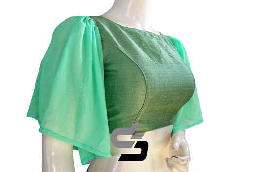 Experience enchantment with "Olive Enchantment," our Plain Silk Designer Ruffle Sleeve Readymade Blouse, radiating sophistication and charm with its elegant design and graceful ruffle sleeves.