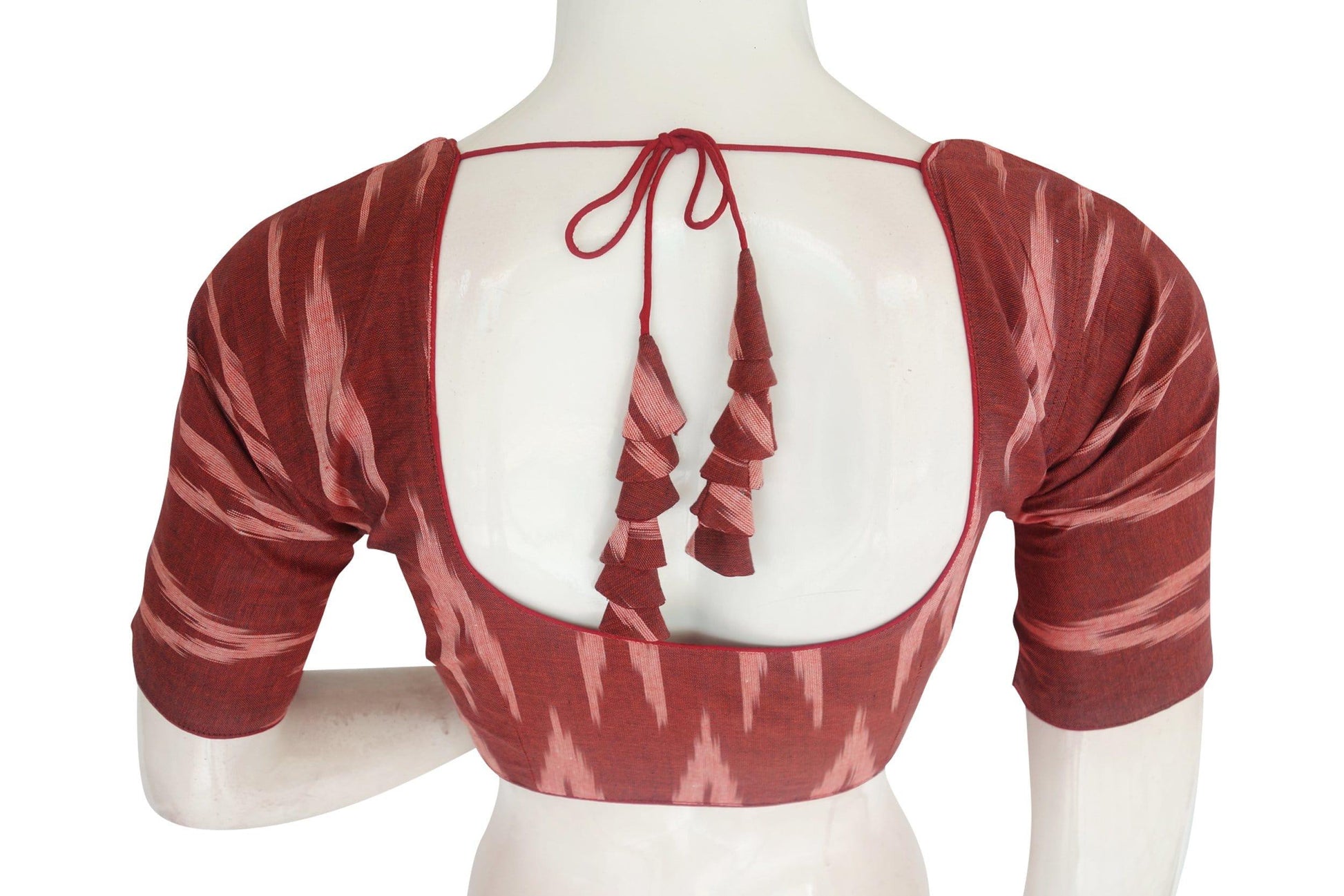 ikkat readymade saree blouse with matching mask 9Elevate your ethnic elegance with our Stylish Maroon Ikkat Readymade Saree Blouse, complete with a matching mask and designer tassels. This ensemble not only adds flair to your traditional attire but also ensures you're fashionably responsible. Discover this chic and responsible fashion choice today!