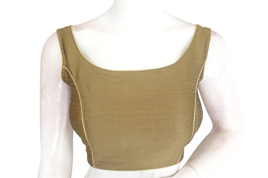 Golden Glow: Illuminate your style with our plain silk designer readymade blouse. This elegant piece radiates sophistication with its golden hue and exquisite craftsmanship. Whether paired with a saree or a skirt, it adds a touch of luxury to any ensemble. Elevate your wardrobe with this timeless staple, perfect for both formal occasions and everyday glamour.